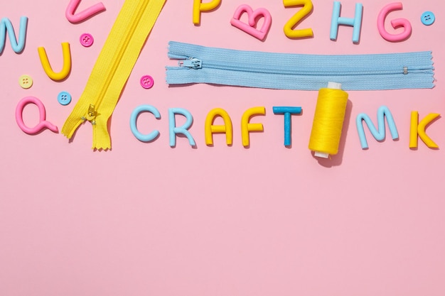 Free Photo the word craft is made of colored plasticine laid out on a pink background