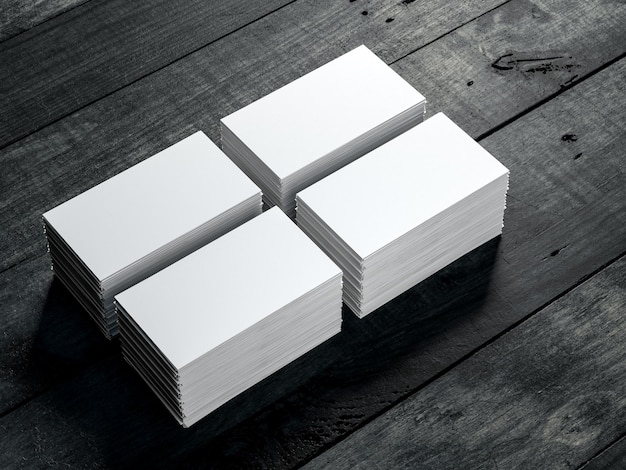 Photo four stacks of white business cards mockup on black wooden table background 3d rendering
