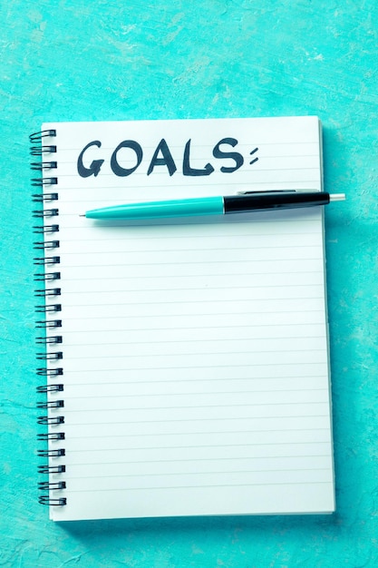Photo goal setting concept handwritten word goals with a pen and a paper notepad